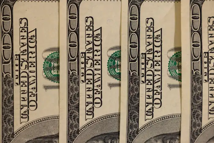 A stack of United States hundred-dollar bills.