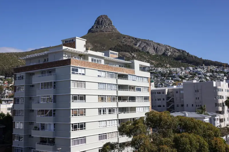 Apartment blocks against a clear sky in Cape Town, South Africa.