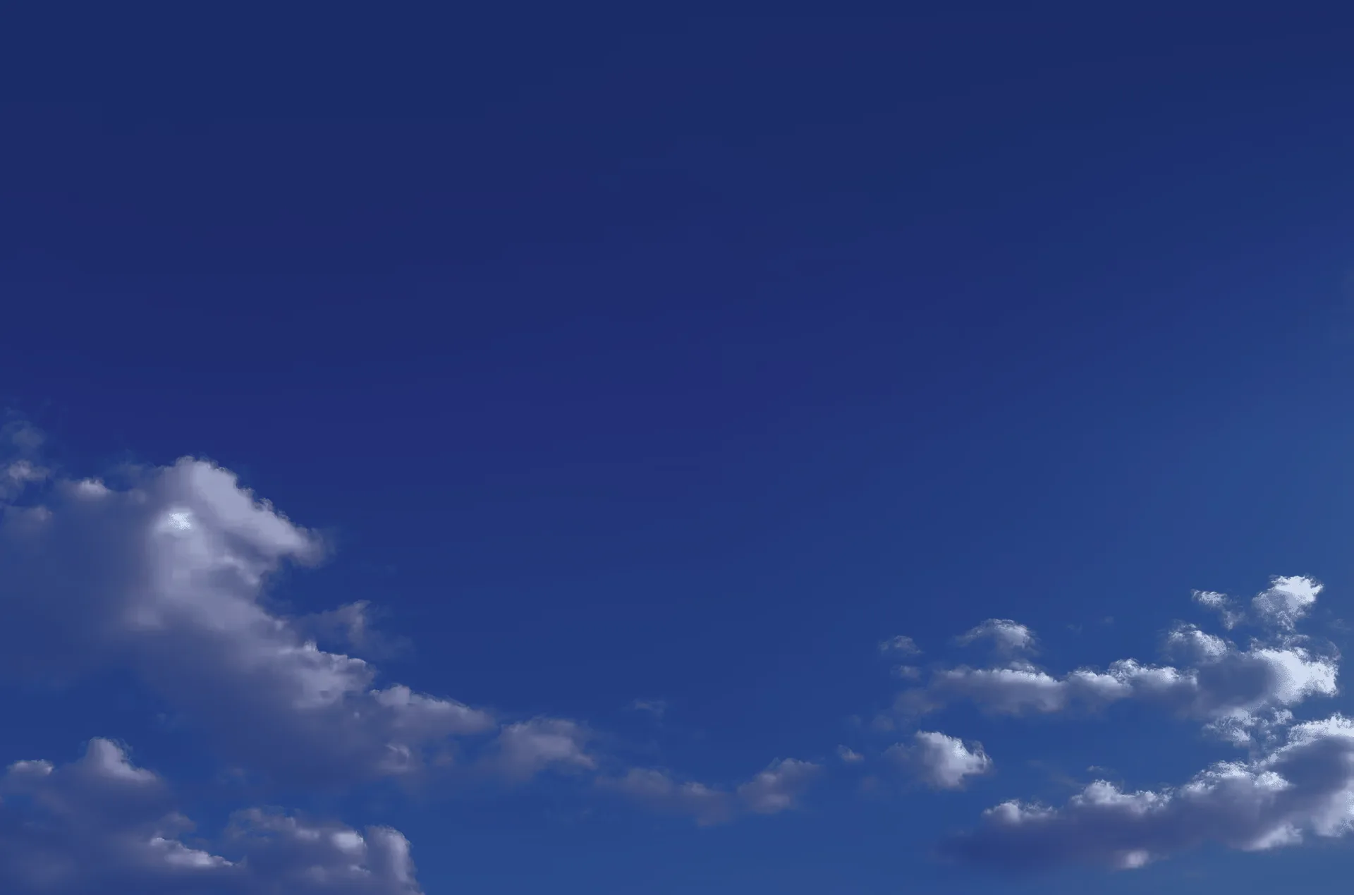 Deep blue sky with scattered cloud.