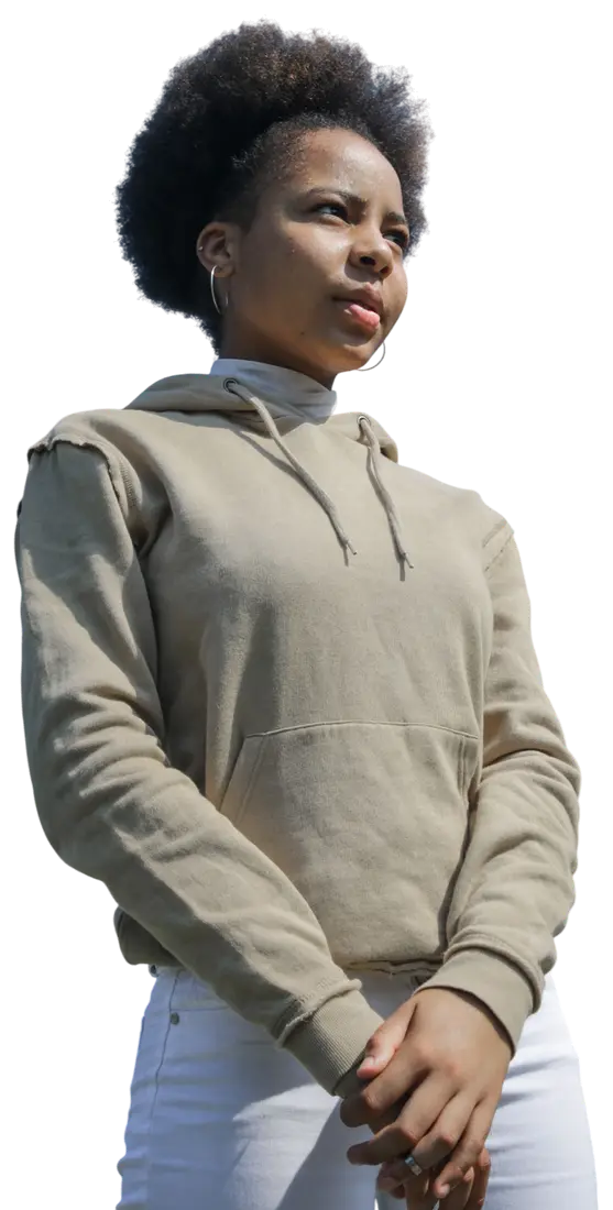A woman standing outdoors, looking out past the camera.